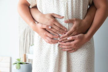 person touching person's belly person touching person's belly