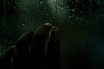 Person Touching Window With Dripping Water Person Touching Window With Dripping Water