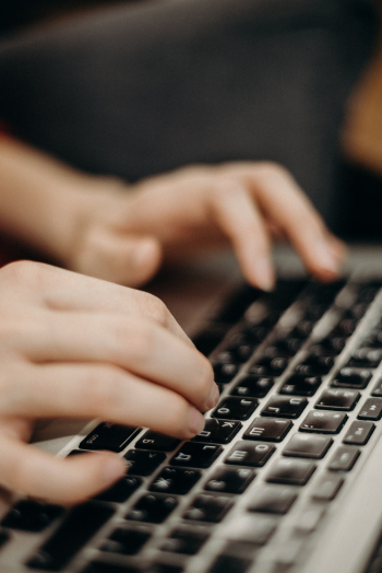 Person Typing on Keyboard Person Typing on Keyboard