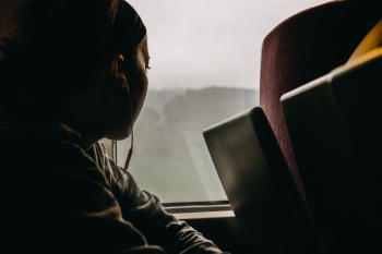 person using earphones looking through window person using earphones looking through window