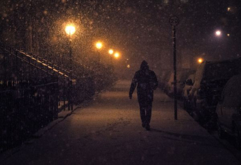 person walking at night with snow person walking at night with snow