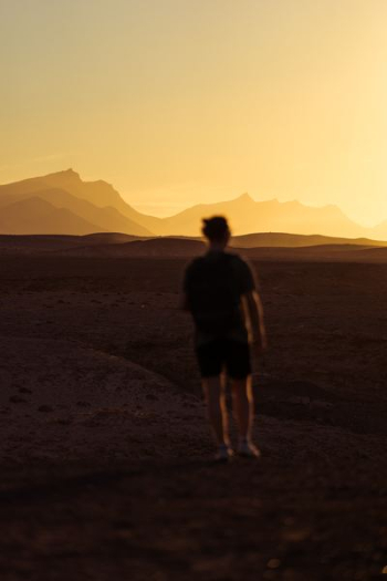 person walking on desert during golden hour person walking on desert during golden hour