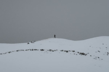 person walking on snow at daytime person walking on snow at daytime