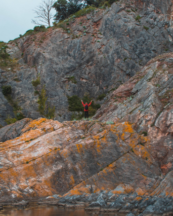Person Waving on Top of Dry Terrain Mountain Person Waving on Top of Dry Terrain Mountain