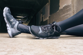 Person Wearing Black-and-gray Under Armour Running Shoes Person Wearing Black-and-gray Under Armour Running Shoes