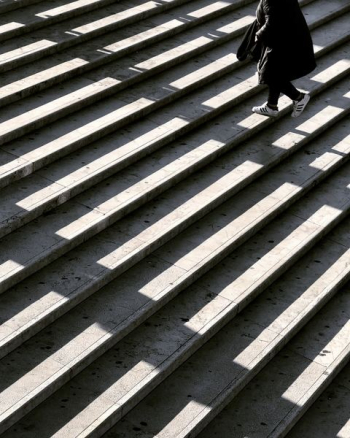 person wearing black jacket walking on stair photography person wearing black jacket walking on stair photography