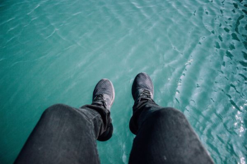 person wearing black sneakers and black pants person wearing black sneakers and black pants
