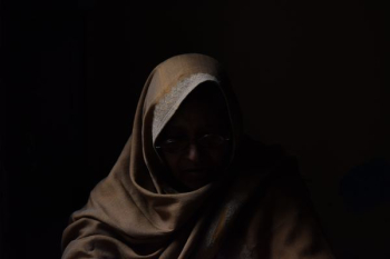 person wearing eyeglasses and robe person wearing eyeglasses and robe