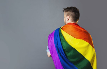 Person Wearing Rainbow Pride Flag Person Wearing Rainbow Pride Flag