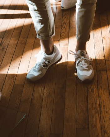 person wearing white New Balance shoes person wearing white New Balance shoes