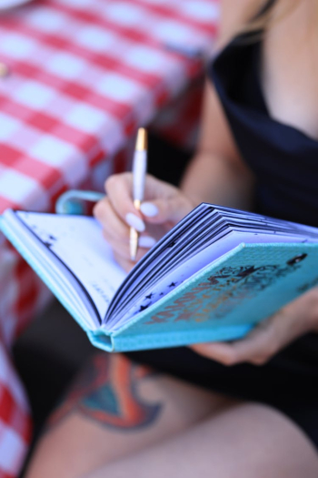 Person Writing on a Planner