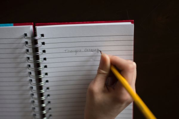 Person Writing on White Lined Paper Person Writing on White Lined Paper