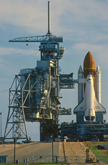 Personal one to one tour. August 1985.
Taken out to launch pad very early morning.
Preparing for Launch  STS-51 
During short window before the Service gantry is closed against the Shuttle “Discovery”. 
This is from a scan I did from a slide film I took,so quality not 100%.
Note…Most travelled shuttle, 149 million miles, 39 missions, 365 days in orbit over 27 years.
Now in the “Smithsonian Air and Space museum”