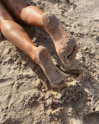 Persons Feet on Brown Sand Persons Feet on Brown Sand