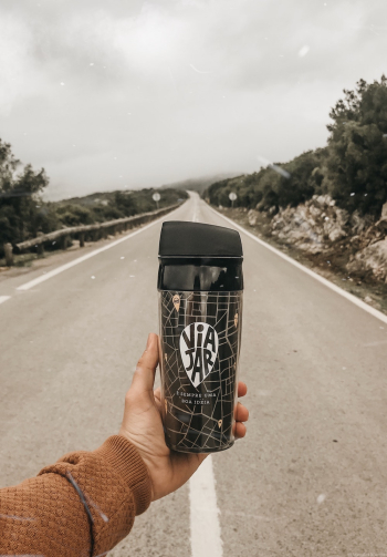 Photo of a Person Holding Tumbler Photo of a Person Holding Tumbler