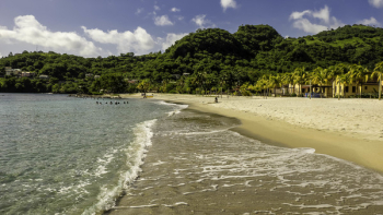 Photo of Beach Near Green Mountain Under Cloudy Sky