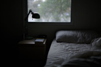 photo of bed near task lamp photo of bed near task lamp