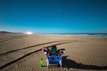 photo of blue and red chair under blue sky photo of blue and red chair under blue sky