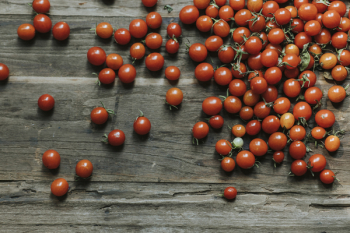 Photo of Cherry Tomatoes on Wooden Surface Photo of Cherry Tomatoes on Wooden Surface