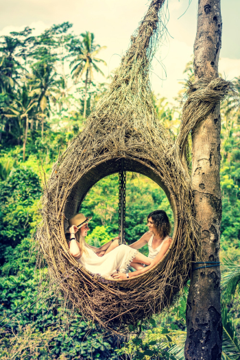 Photo of Couple Sitting on Hammock Photo of Couple Sitting on Hammock