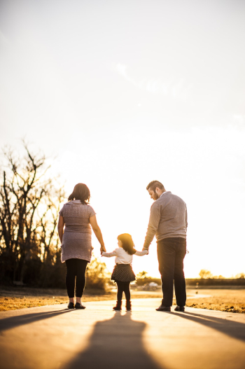 Photo of Family Standing Outdoors During Golden Hour Photo of Family Standing Outdoors During Golden Hour