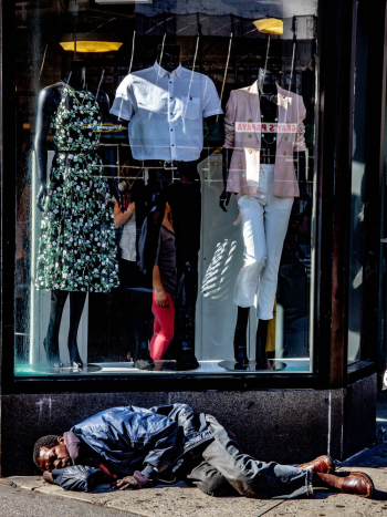 Photo of Homeless Man Sleeping In Front of Clothing Store Photo of Homeless Man Sleeping In Front of Clothing Store