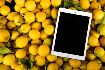 Photo of Ipad on Pile of Lemons Photo of Ipad on Pile of Lemons