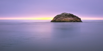 Photo of Island on Sea during Sunset Photo of Island on Sea during Sunset