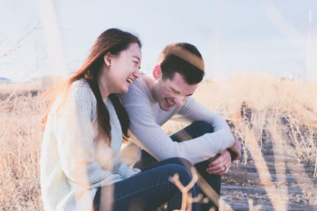 photo of man and woman laughing during daytime photo of man and woman laughing during daytime