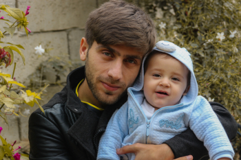 Photo of Man Carrying Baby Photo of Man Carrying Baby