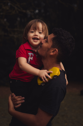 Photo of Man Carrying His Child Photo of Man Carrying His Child