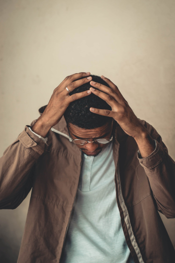 Photo of Man Holding His Head Photo of Man Holding His Head