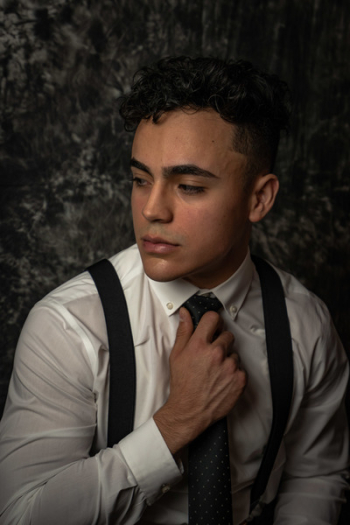Photo of Man Holding His Necktie Photo of Man Holding His Necktie