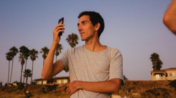 Photo Of Man Holding Smartphone Photo Of Man Holding Smartphone