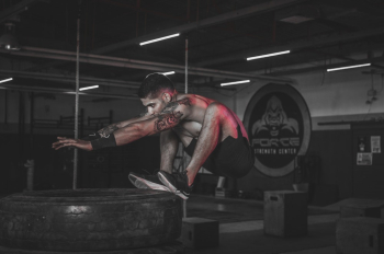 Photo of Man Jumping on Tires Photo of Man Jumping on Tires