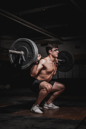 Photo of Man Lifting Barbell Photo of Man Lifting Barbell