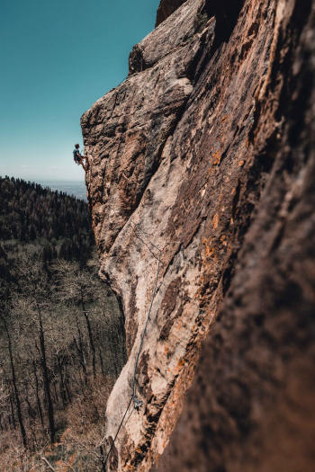 Photo Of Man Rock Climbing Photo Of Man Rock Climbing