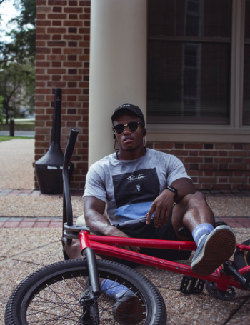 Photo of Man Sitting in Front of Bmx Bike