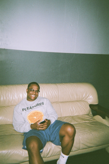 Photo of Man Sitting on Leather Sofa Photo of Man Sitting on Leather Sofa