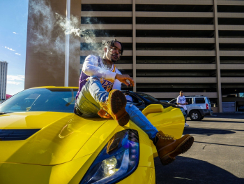 Photo of Man Sitting on Yellow Corvette Stingray Photo of Man Sitting on Yellow Corvette Stingray