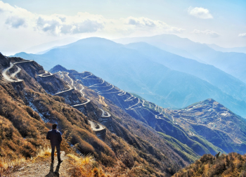 Photo of Man Standing Near Cliff Edge