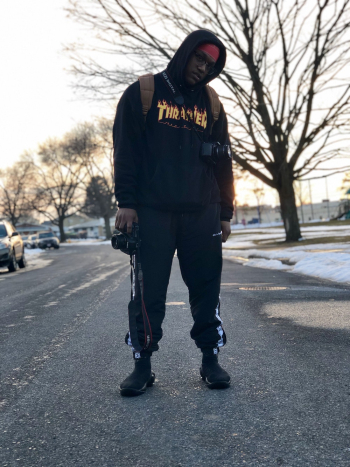 Photo of Man Wearing Hoodie Standing on Road Photo of Man Wearing Hoodie Standing on Road