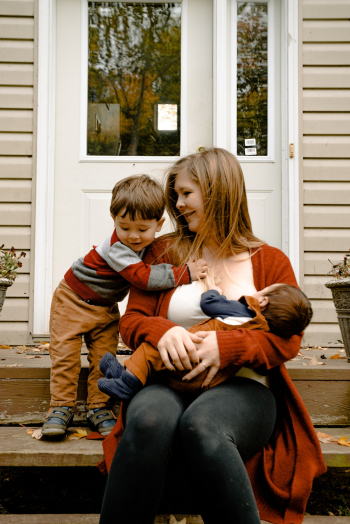 Photo Of Mother Carrying Her Child Photo Of Mother Carrying Her Child