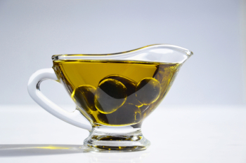 Photo of Olives on Cup of Olive Oil Photo of Olives on Cup of Olive Oil