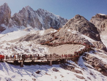 Photo of People Climbing Towards Rocky Mountain Photo of People Climbing Towards Rocky Mountain