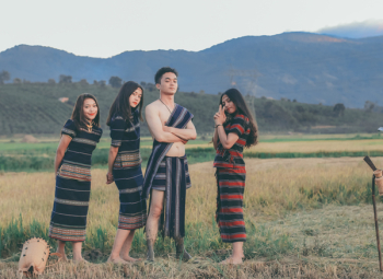 Photo of People Holding Traditional Clothes Photo of People Holding Traditional Clothes