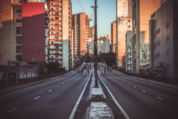 Photo of People Walking on Road Near Buildings Photo of People Walking on Road Near Buildings