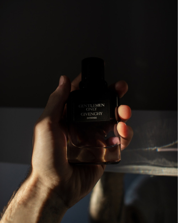 Photo of Person Holding a Gentlemen Only Cologne Bottle by Givenchy Photo of Person Holding a Gentlemen Only Cologne Bottle by Givenchy