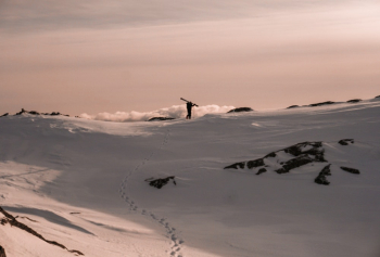 Photo of Person Walking on Snowy Field Photo of Person Walking on Snowy Field