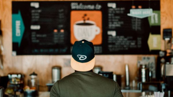 photo of person wearing cap staring at menu board photo of person wearing cap staring at menu board
